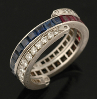 Appraisal: A diamond ruby and sapphire swivel ring Comprising a central