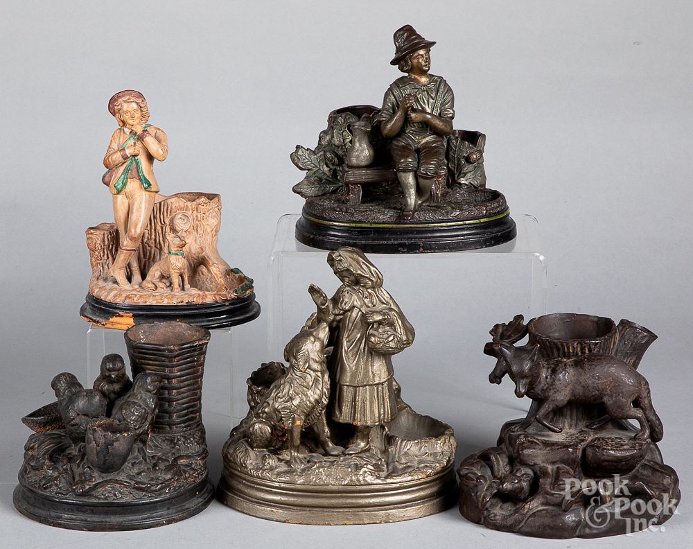 Appraisal: Five figural cigar match holder and strikers Five terra cotta