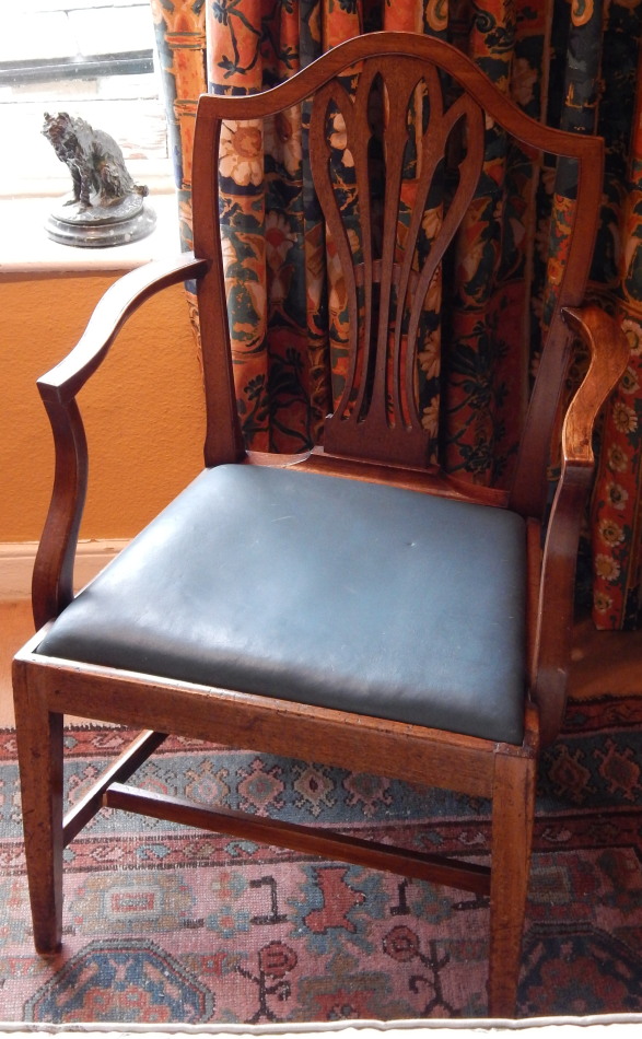 Appraisal: A George III mahogany open arm chair the shield shaped