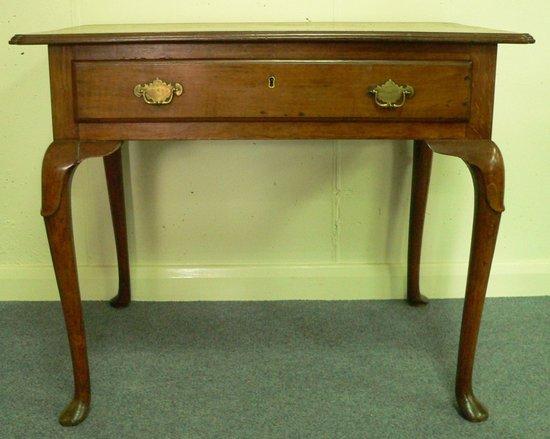 Appraisal: An th Century fruitwood table the top with moulded canted