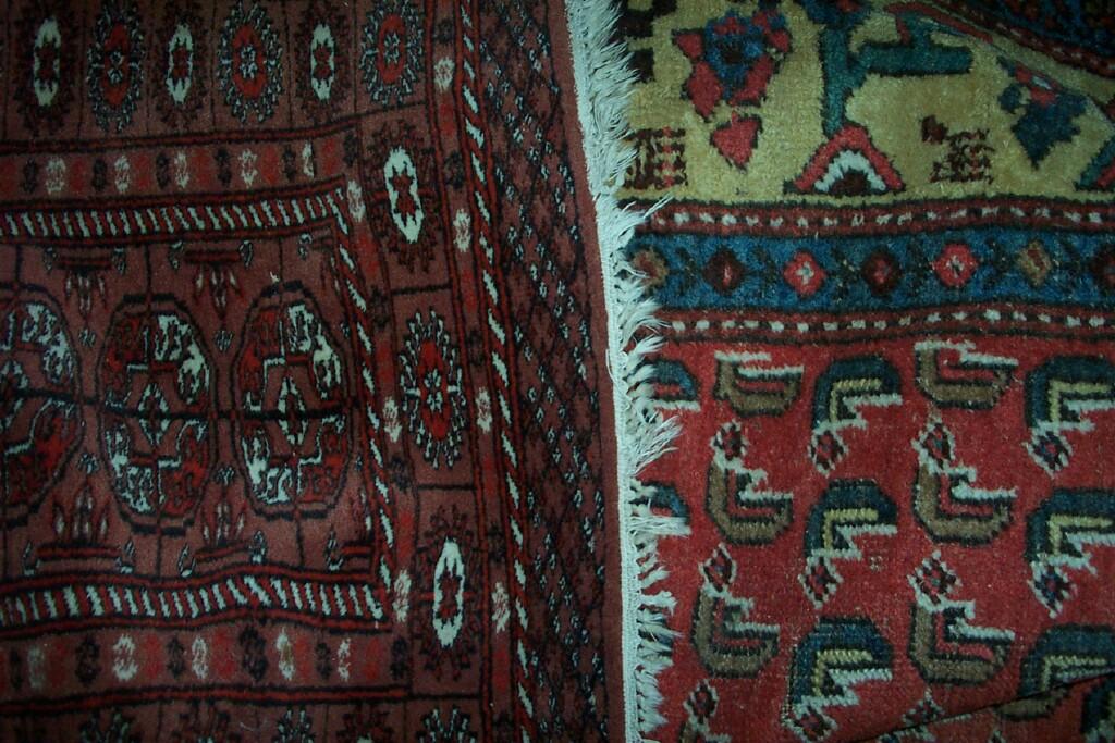 Appraisal: A red ground eastern wool carpet with repeating decoration in