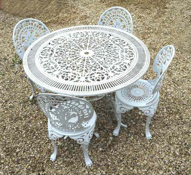 Appraisal: A WHITE PAINTED PIERCED FRETWORK ALUMINIUM GARDEN TABLE together with