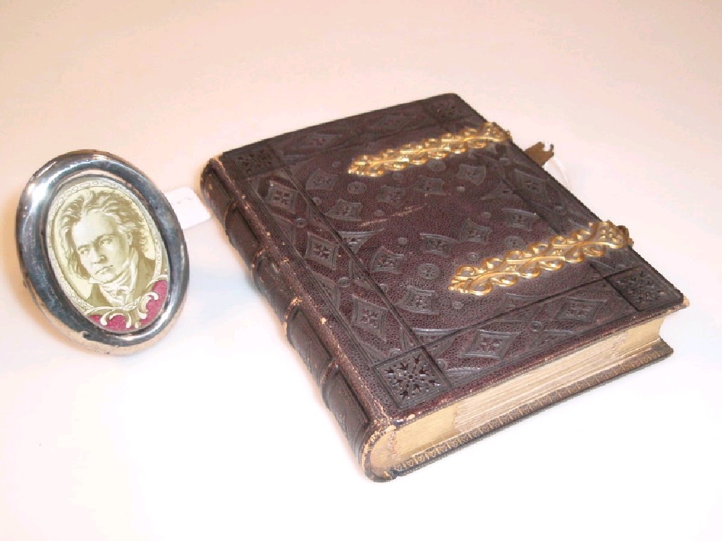 Appraisal: A Victorian small brevety' photograph album with embossed Morocco covers