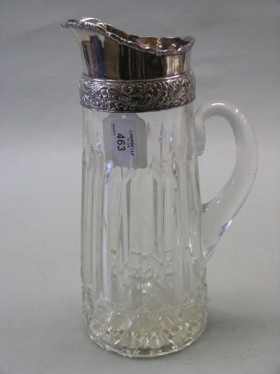 Appraisal: A large glass water jug with silver plated mount in