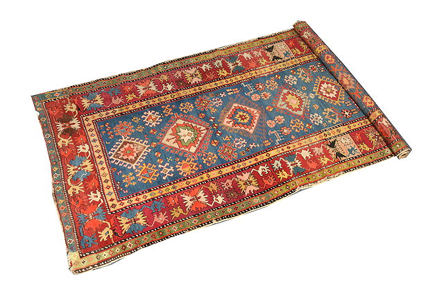 Appraisal: AN OLD CAUCASIAN LIGHT BLUE GROUND RUG with seven hooked