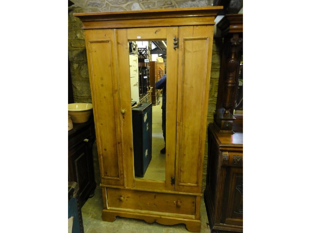 Appraisal: A Victorian stripped pine wardrobe enclosed by a single mirror