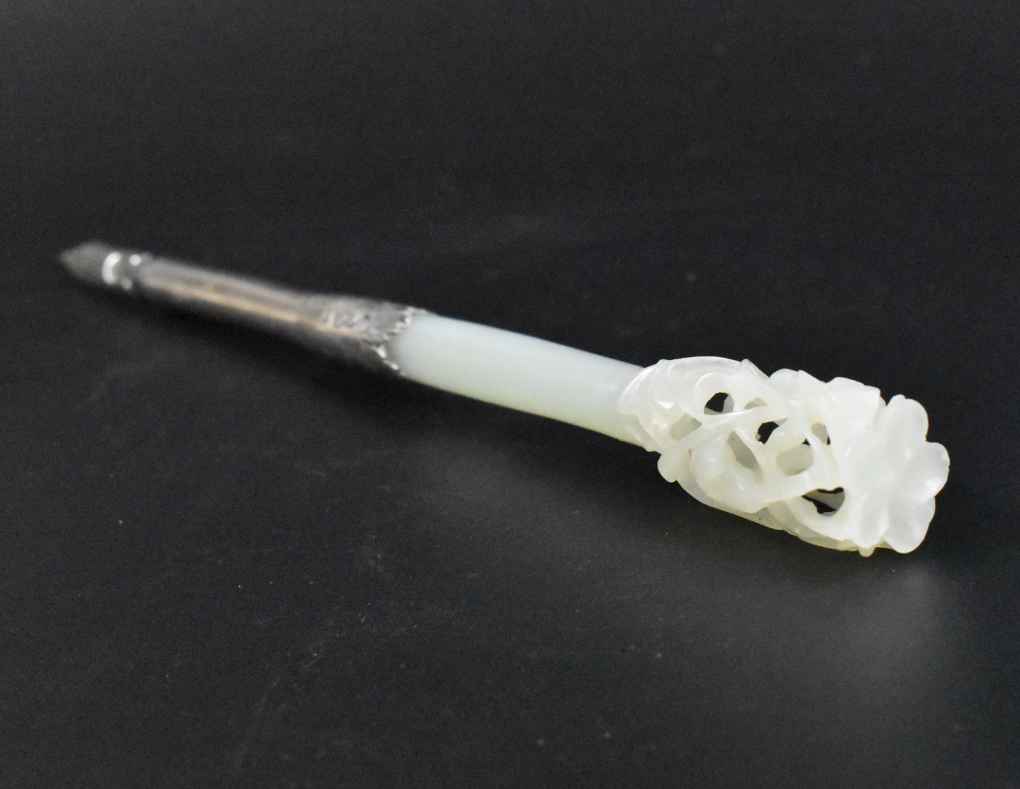 Appraisal: A Chinese silver mounted jade carved pen dating from the