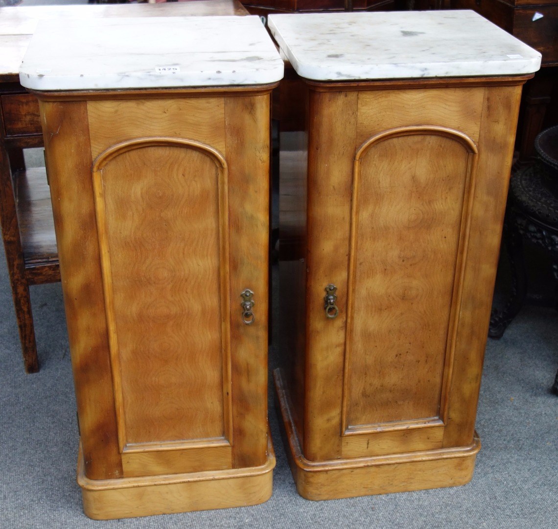 Appraisal: A pair of th century satinwood pot cupboards with marble