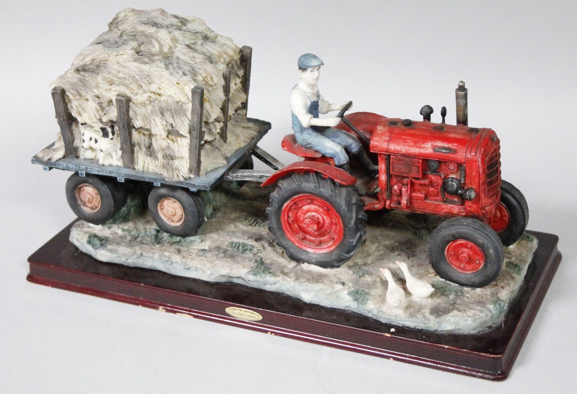 Appraisal: A thC Juliana sculpture of farmer on green tractor pulling