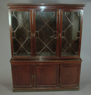 Appraisal: A mahogany triple bookcase mid th century the moulded top