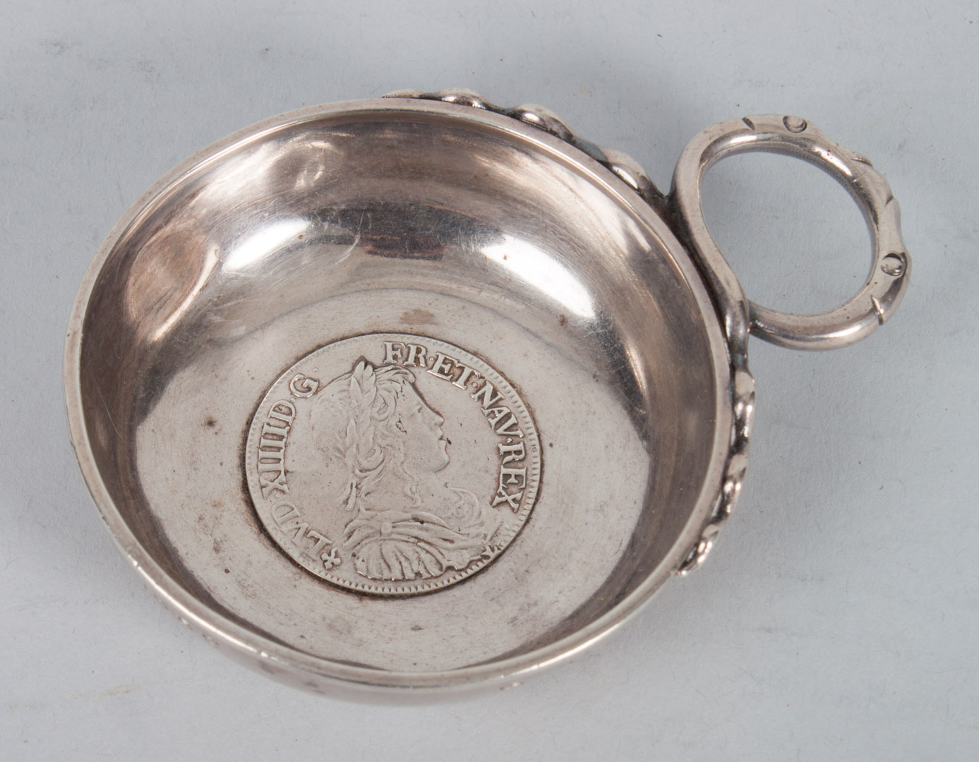 Appraisal: French silver wine taster with a Louis XIV silver ecu