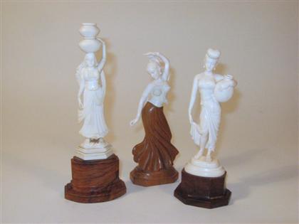 Appraisal: Three Indian elephant ivory and teak figuresComprising two water carriers