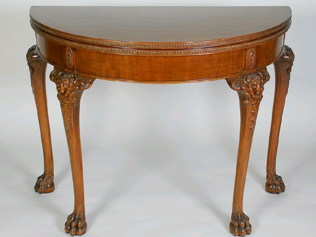 Appraisal: CARVED MAHOGANY DEMI-LUNE CARD TABLE IN THE NEO CLASSICAL TASTE