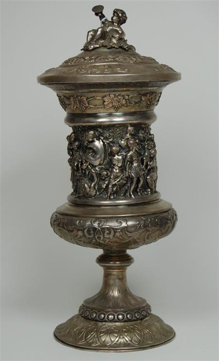 Appraisal: A silver plated cup and cover the central section of