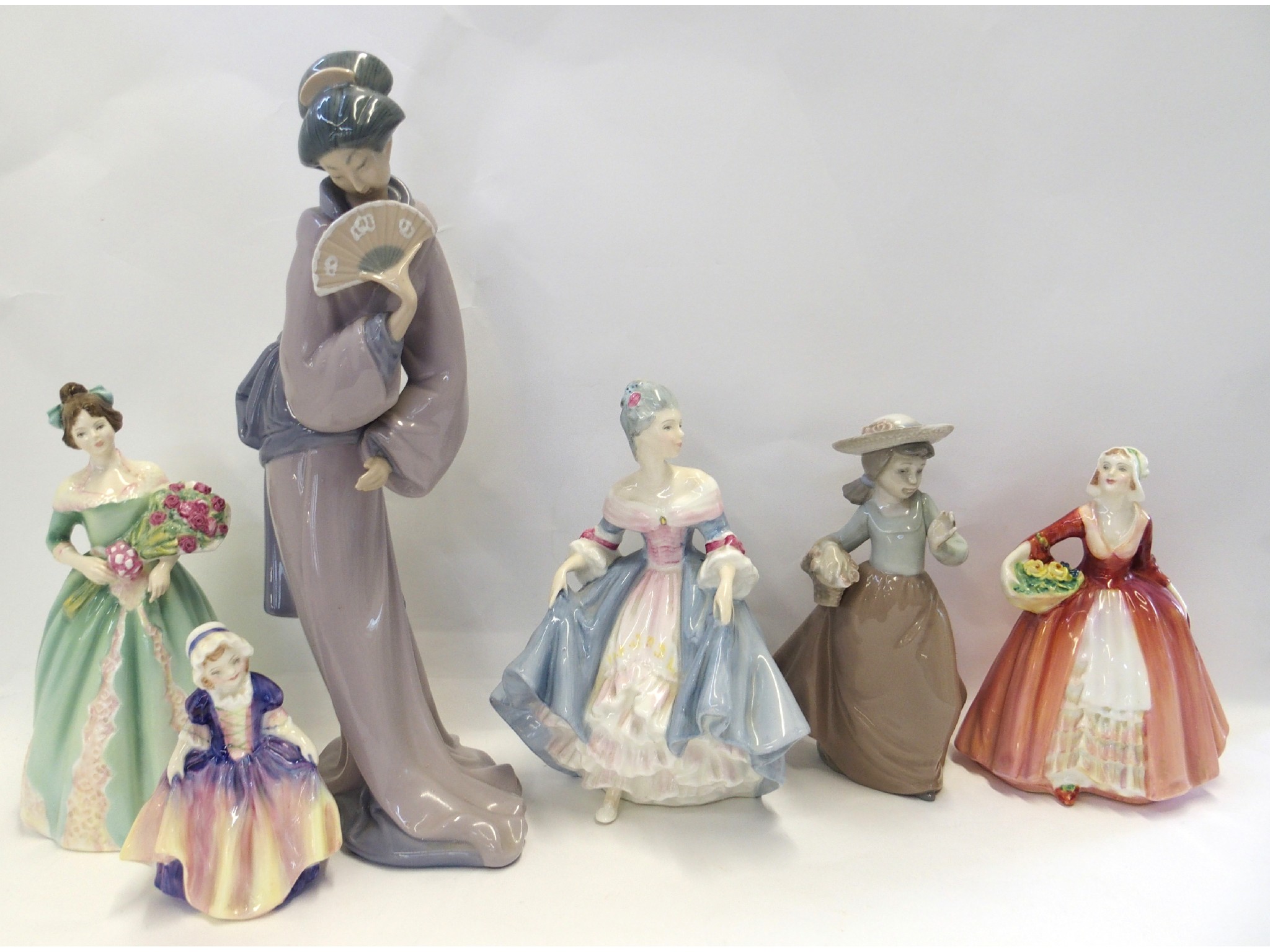 Appraisal: Four Royal Doulton figures including Happy Birthday HN Southern Belle