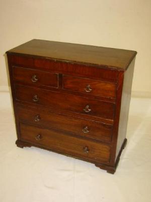 Appraisal: A MAHOGANY MINIATURE CHEST with moulded edged top banded frieze