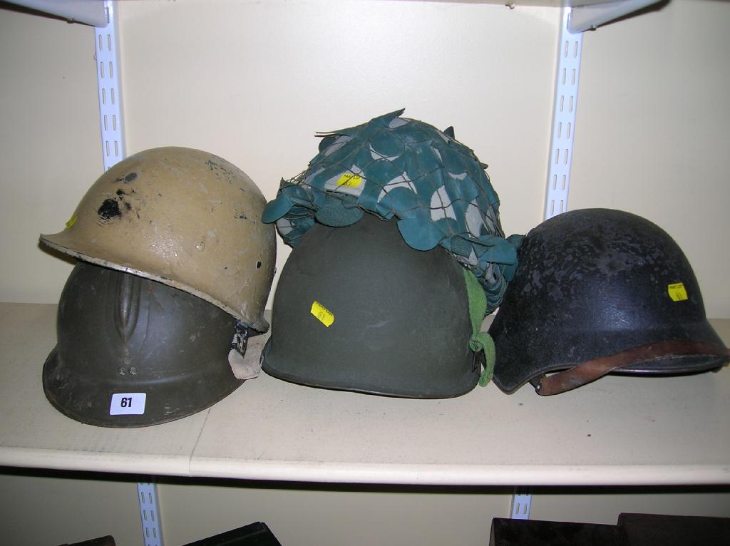 Appraisal: Five assorted steel helmets US complete with liner Swiss French