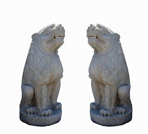 Appraisal: A pair of massive white marble guardian lions seated on