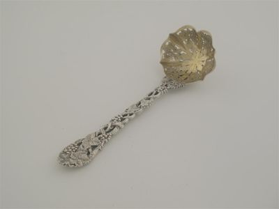 Appraisal: A Victorian pierced-vine sugar sifter ladle fret pierced in the