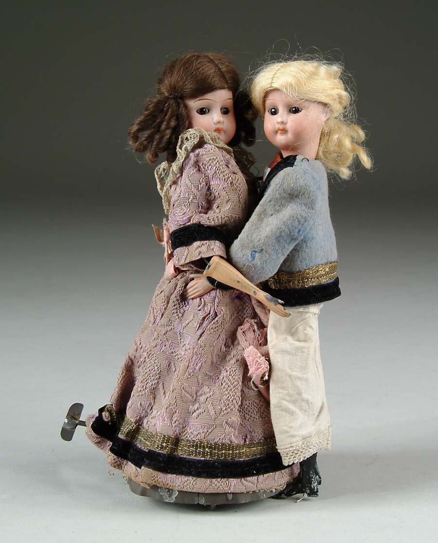 Appraisal: WALTZING COUPLE AUTOMATON Mechanical windup toy of young man and