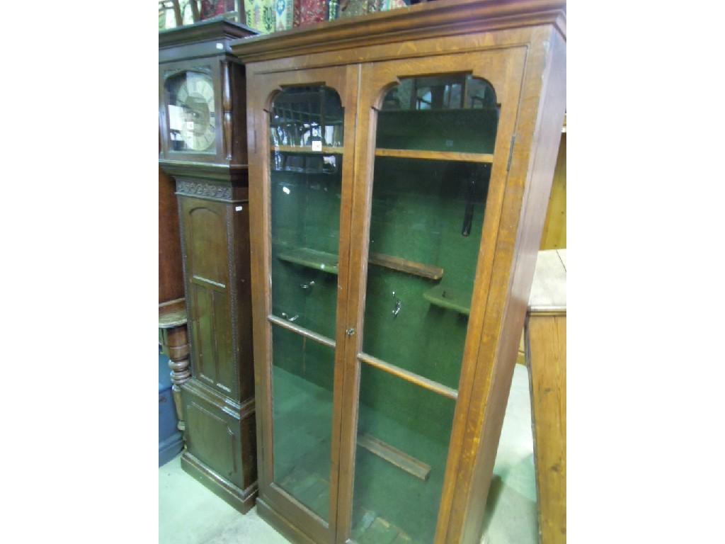 Appraisal: An oak freestanding side cabinet with stepped and moulded cornice