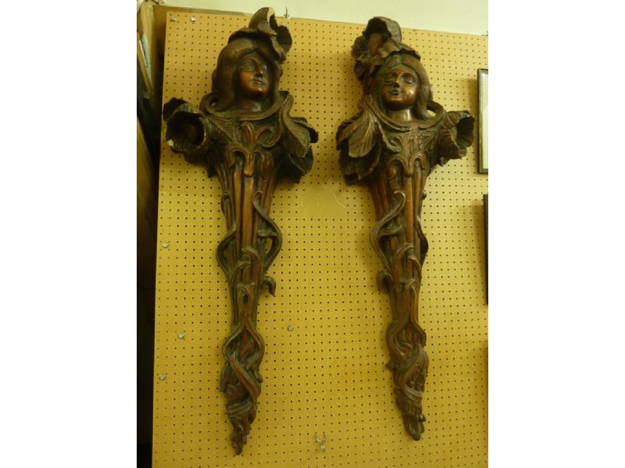 Appraisal: A pair of Art Nouveau carved timber wall mounts of