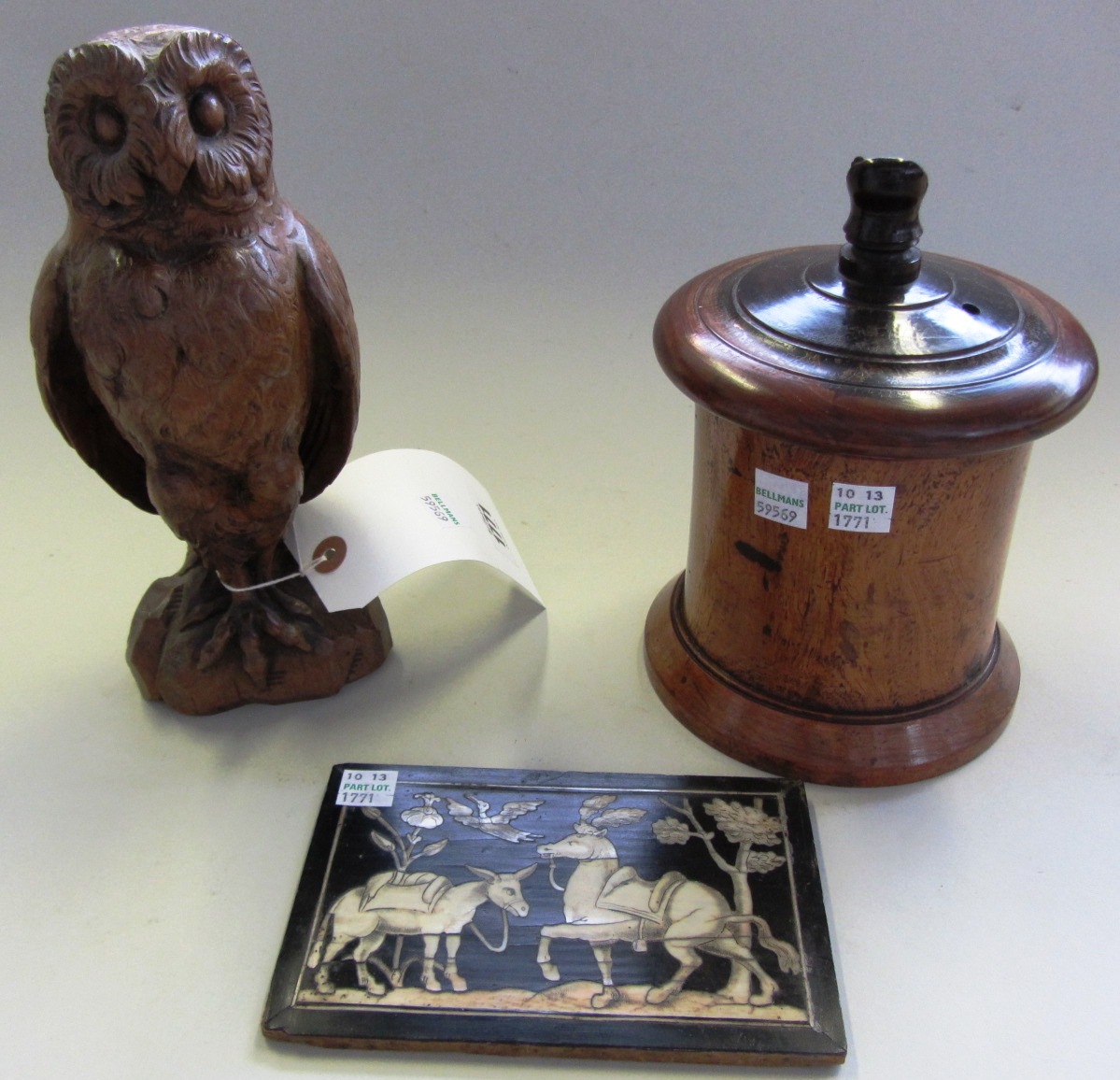 Appraisal: A carved oak owl th century modelled atop a rock