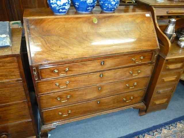 Appraisal: A GEORGE III MAHOGANY BUREAU the fall front enclosing a