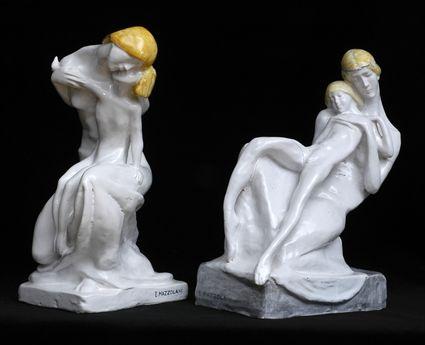 Appraisal: PAIR OF ITALIAN IVORY-GLAZED MAJOLICA FIGURE GROUPS BY E MAZZOLANI