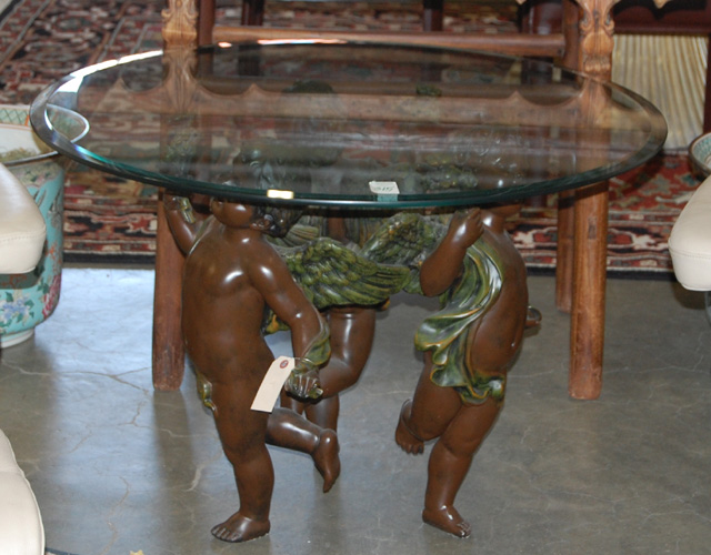 Appraisal: FIGURAL GLASS-TOP TABLE featuring a group of three cherub figures