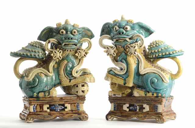 Appraisal: PAIR UNUSUAL CHINESE POTTERY FOO DOGS having shell-like protuberance over