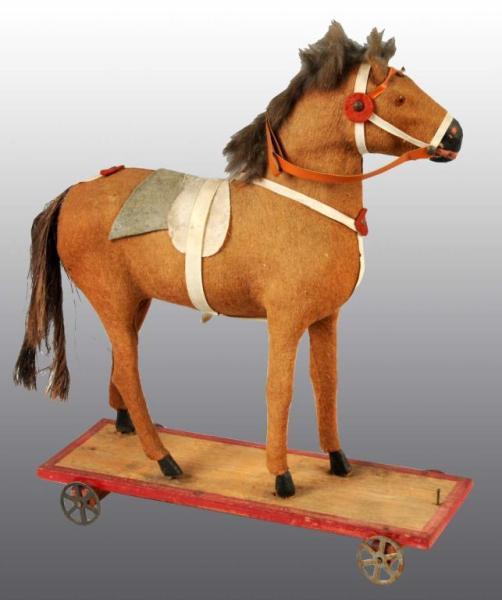 Appraisal: Horse Pull Toy Description Wooden platform with metal wheels The