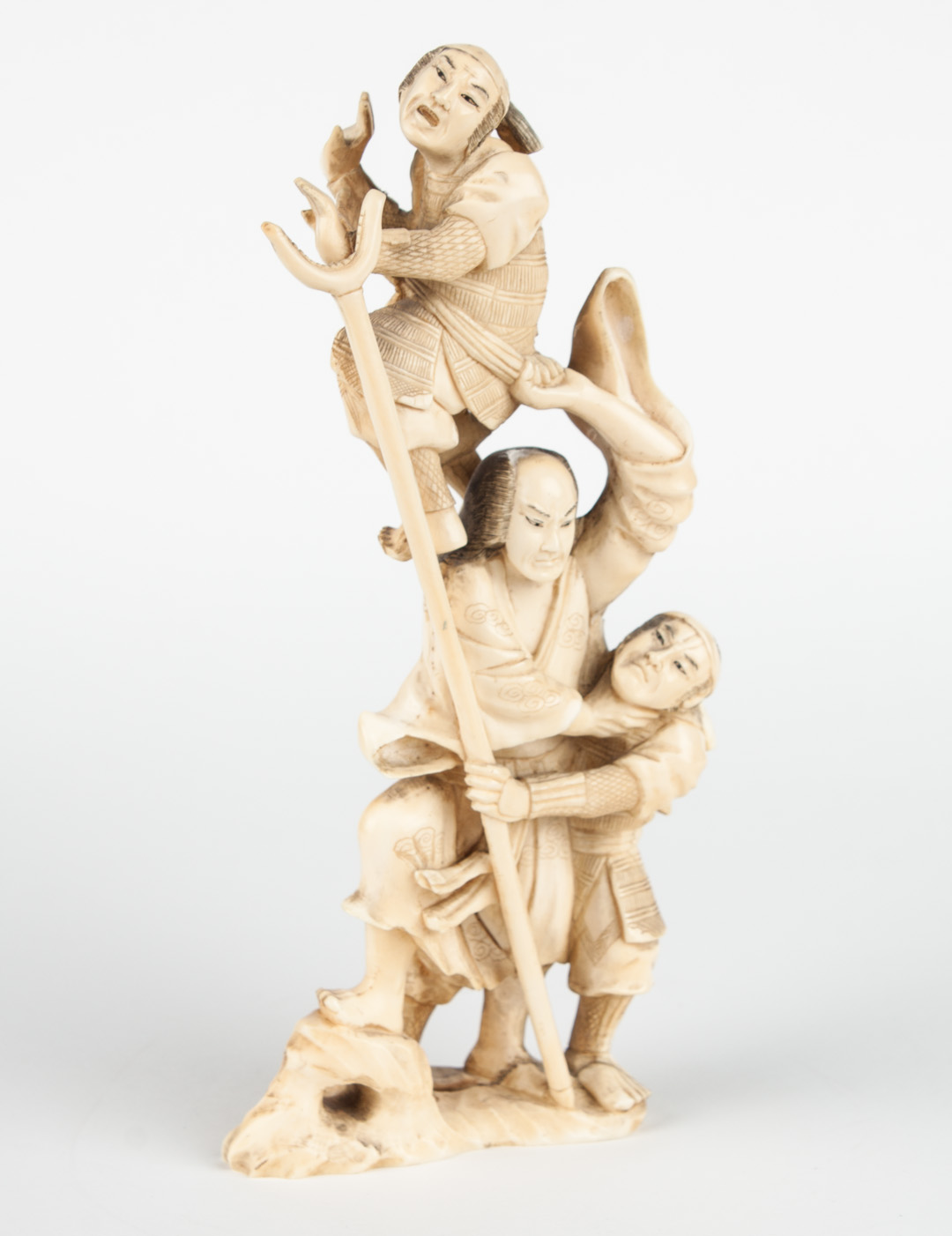 Appraisal: Japanese carved ivory warrior group modeled as three battling samurai