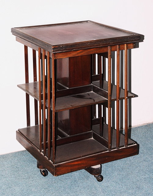 Appraisal: AN EDWARDIAN MAHOGANY REVOLVING BOOKCASE with square top and chamfered