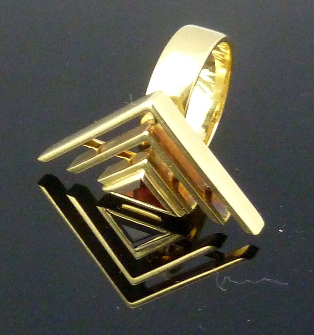 Appraisal: A s ring of stylised triangular form set with a