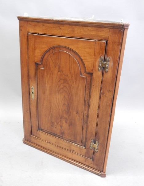 Appraisal: A late thC early thC elm corner cabinet with single