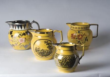 Appraisal: FOUR STAFFORDSHIRE YELLOW-GROUND ENAMEL-DECORATED TRANSFER-PRINTED AND SILVER LUSTRE RESIST JUGS