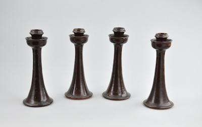 Appraisal: Four Jugtownware Candleholders Each brown glazed ceramic candleholder measures approx