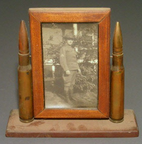 Appraisal: WWI wooden trench art picture frame flanked by two cal