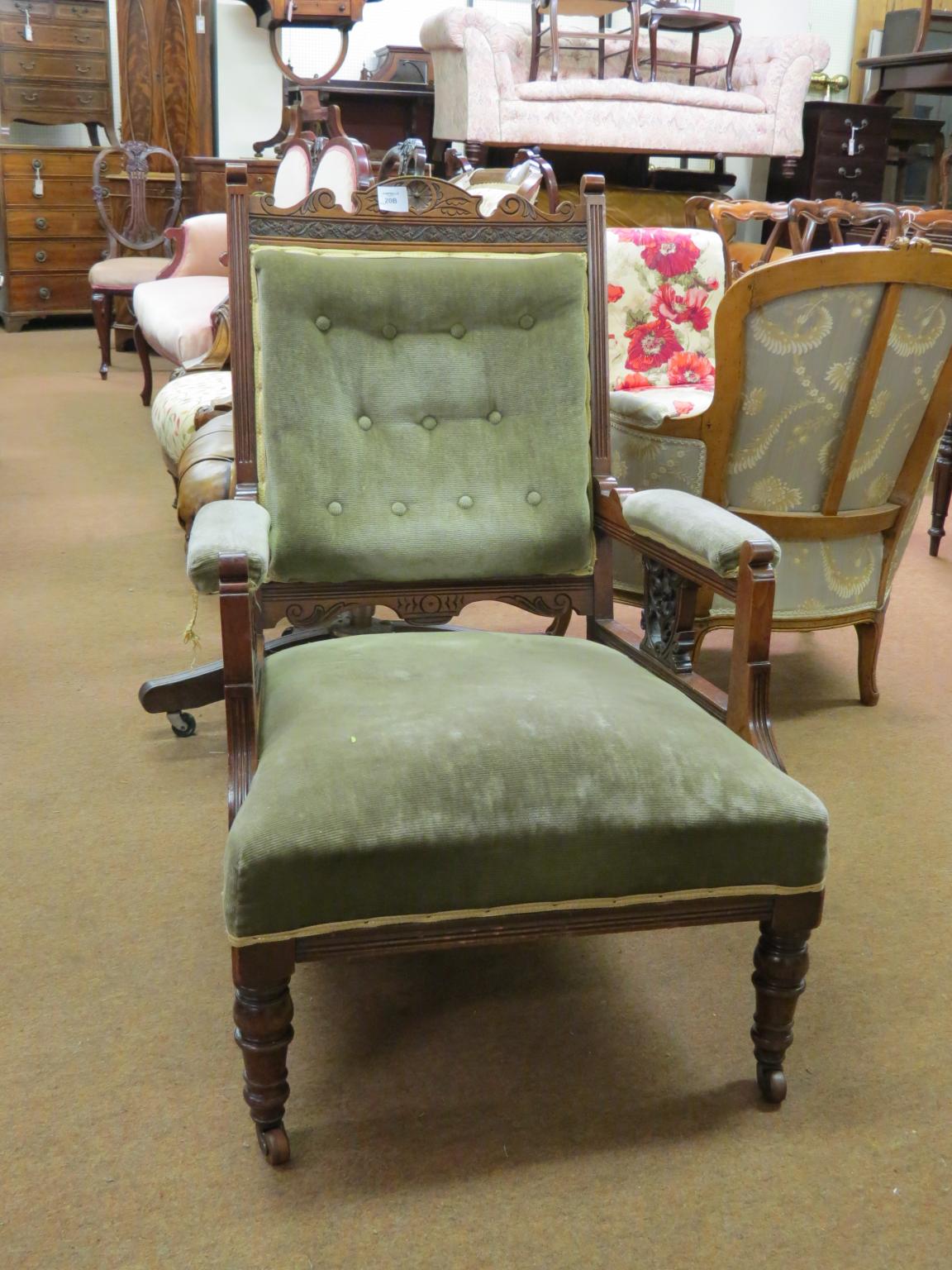 Appraisal: An Edwardian walnut armchair with carved detail on front turned