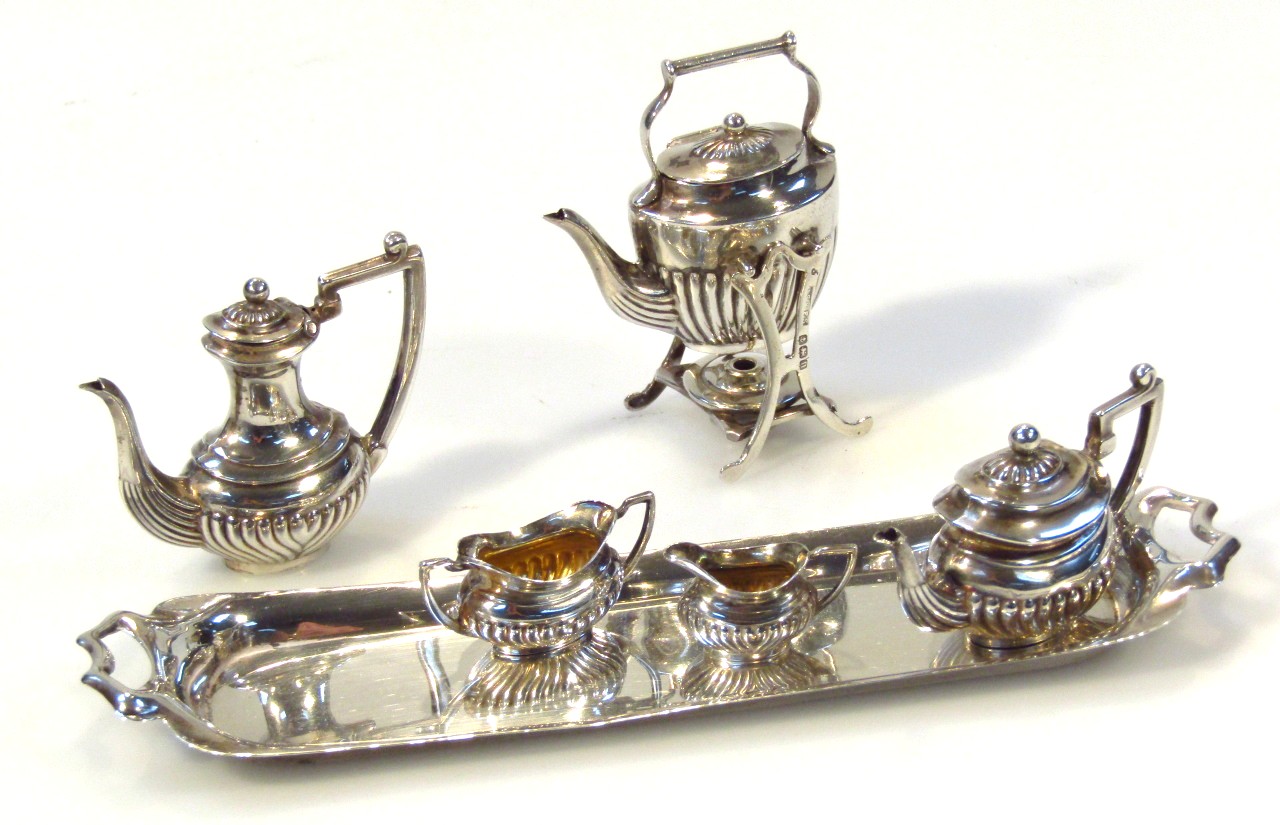 Appraisal: An Edwardian novelty silver miniature service by Reynolds Westwood comprising