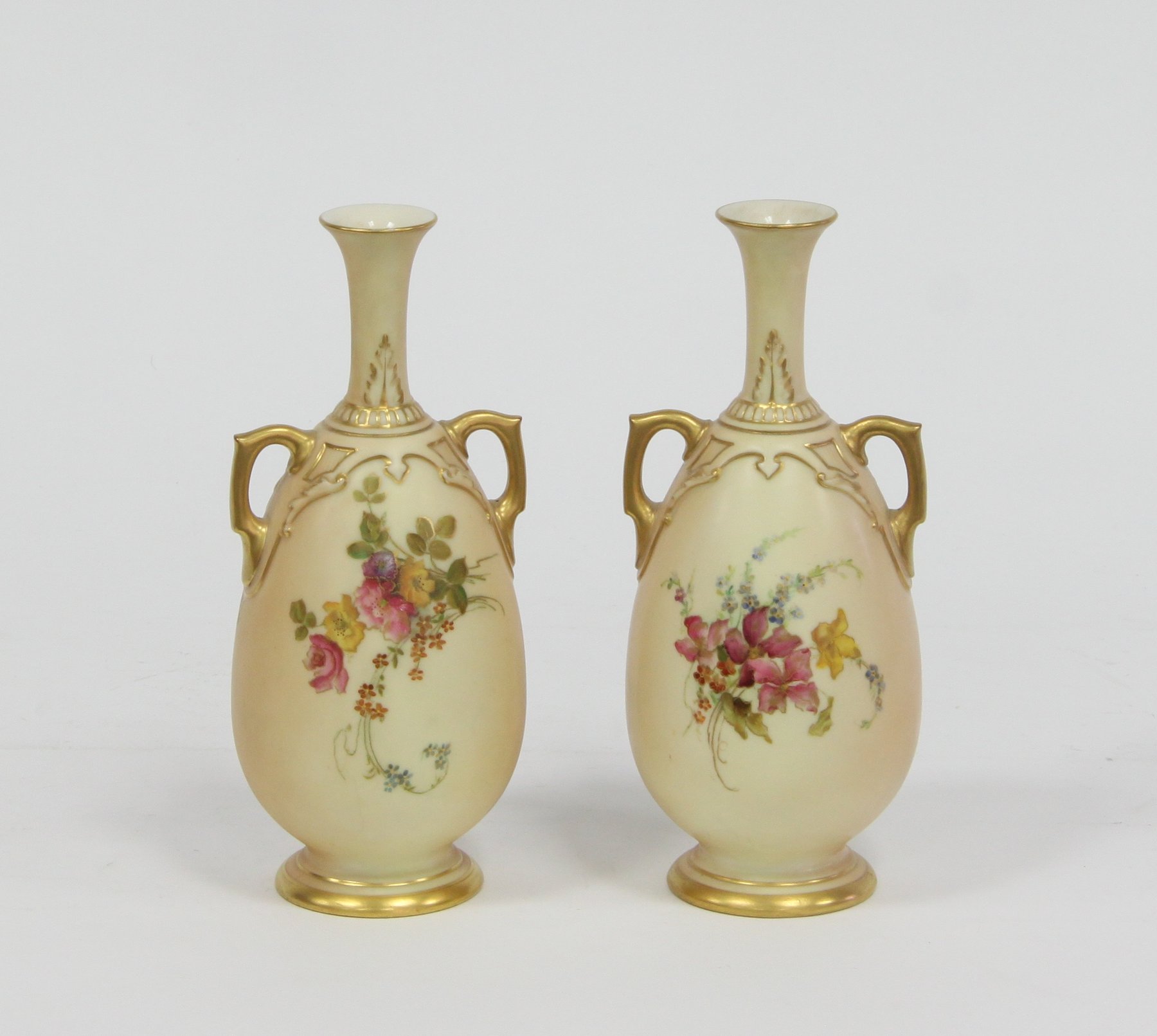 Appraisal: A pair of Royal Worcester blush ivory two-handled vases painted