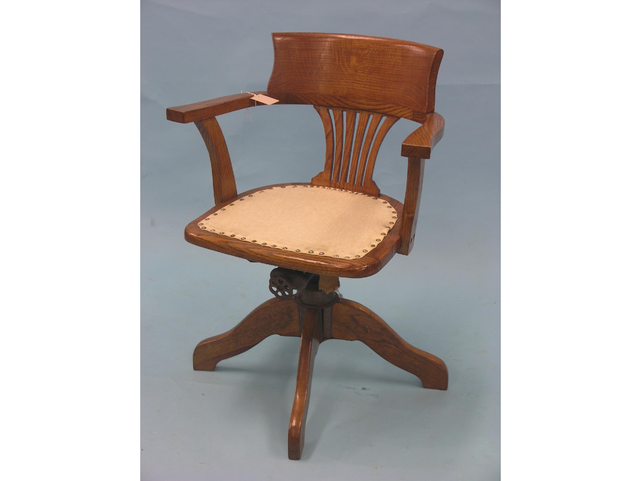 Appraisal: A medium oak office armchair swivel-action with padded seat together