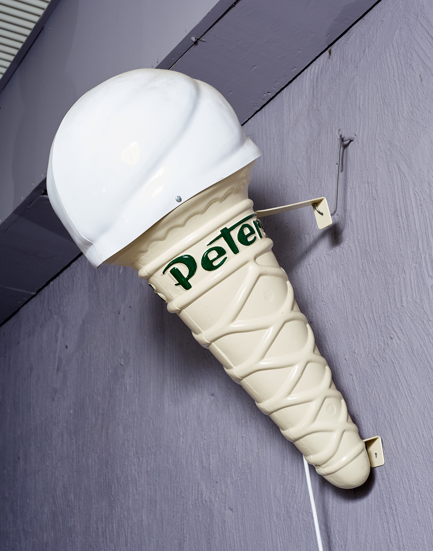 Appraisal: A REPRODUCTION 'PETERS' ICE-CREAM CONE SIGN Cast alloy and plastic