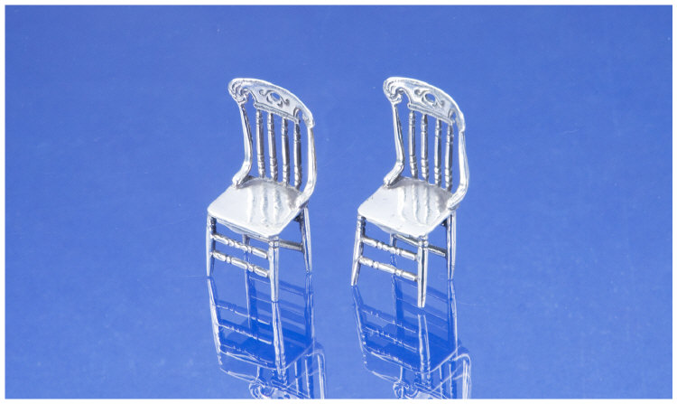 Appraisal: A Pair of Miniature Novelty Silver Spindle Back Chairs Well