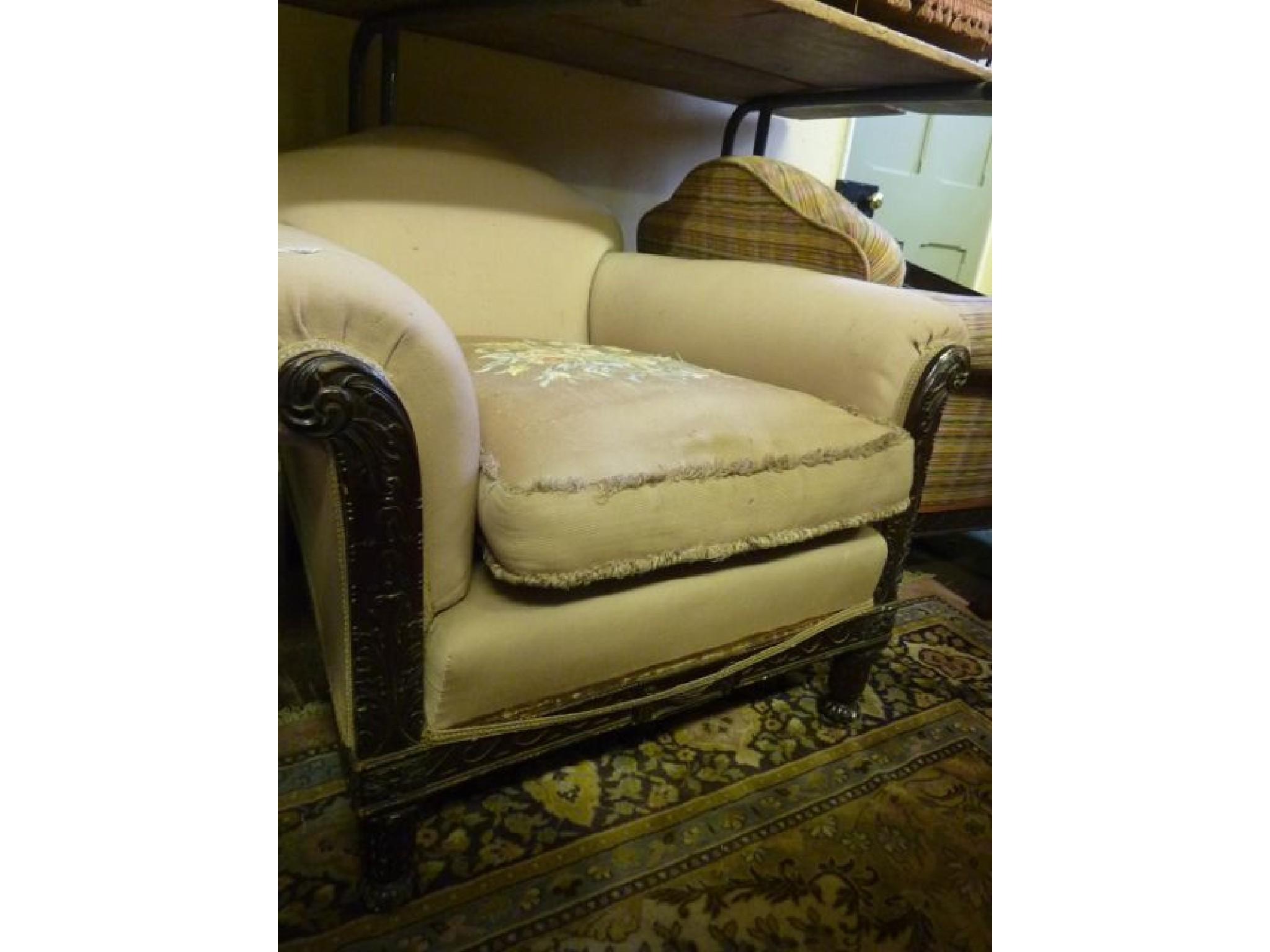 Appraisal: A pair of Edwardian armchairs deep seated with arched backs