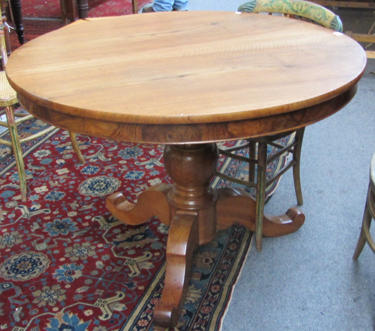 Appraisal: An early th century French walnut circular extending dining table