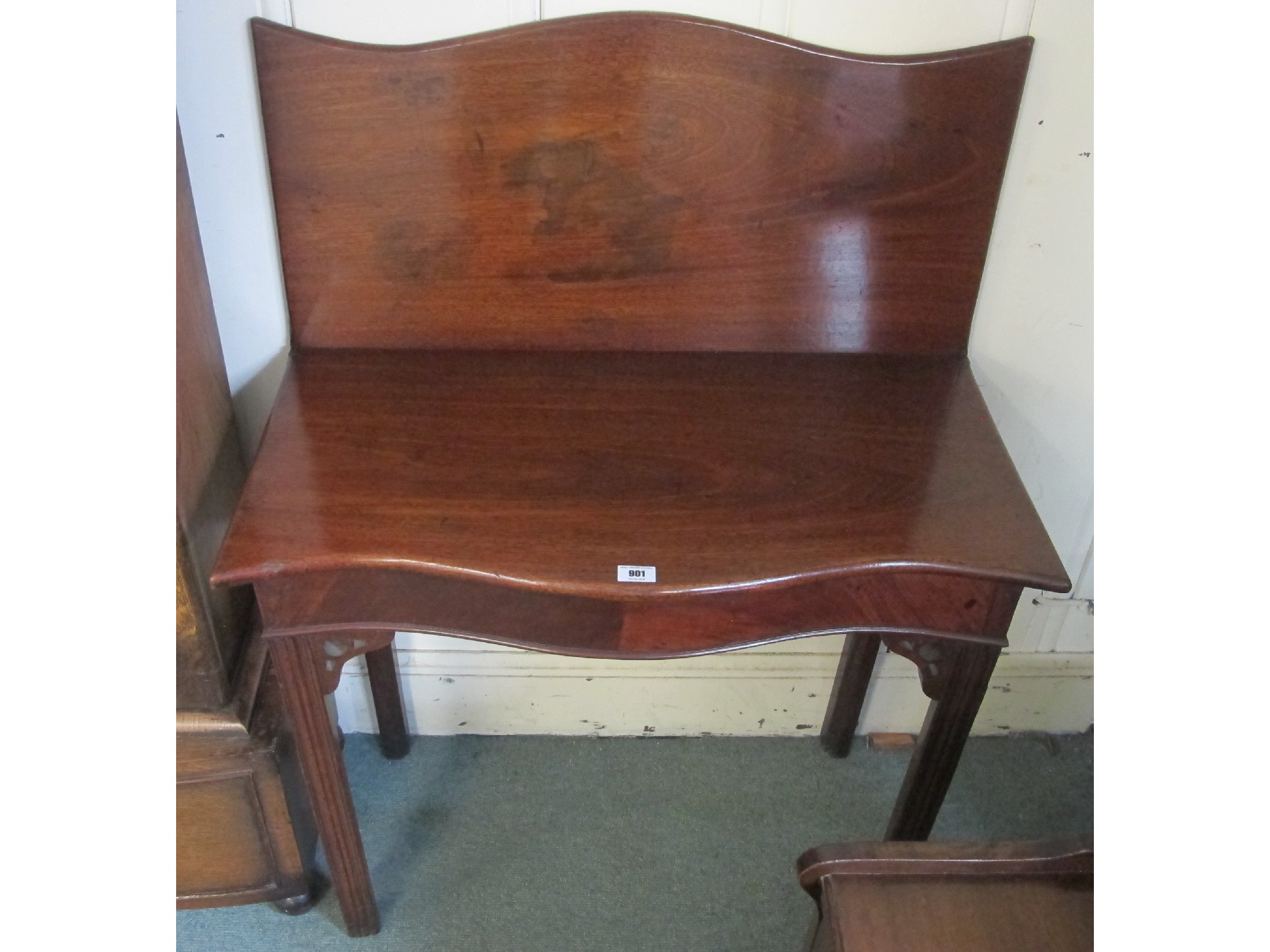 Appraisal: A Georgian mahogany serpentine fold over table