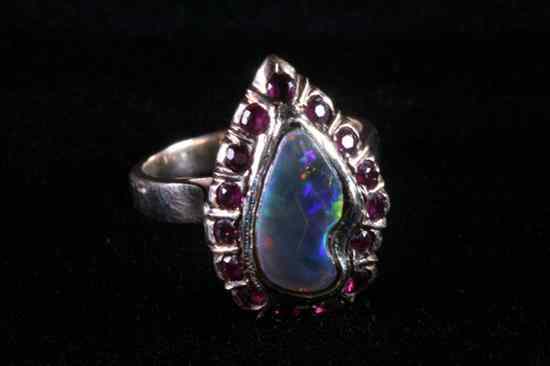 Appraisal: K YELLOW GOLD GARNET AND BLACK OPAL RING Asymetrical black