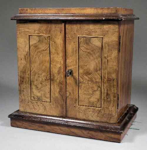 Appraisal: A Victorian walnut collector's cabinet the doors enclosing three drawers